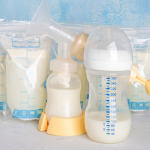 Bags with breast milk. Breast pump on yellow background. Milk bank, storing breast milk