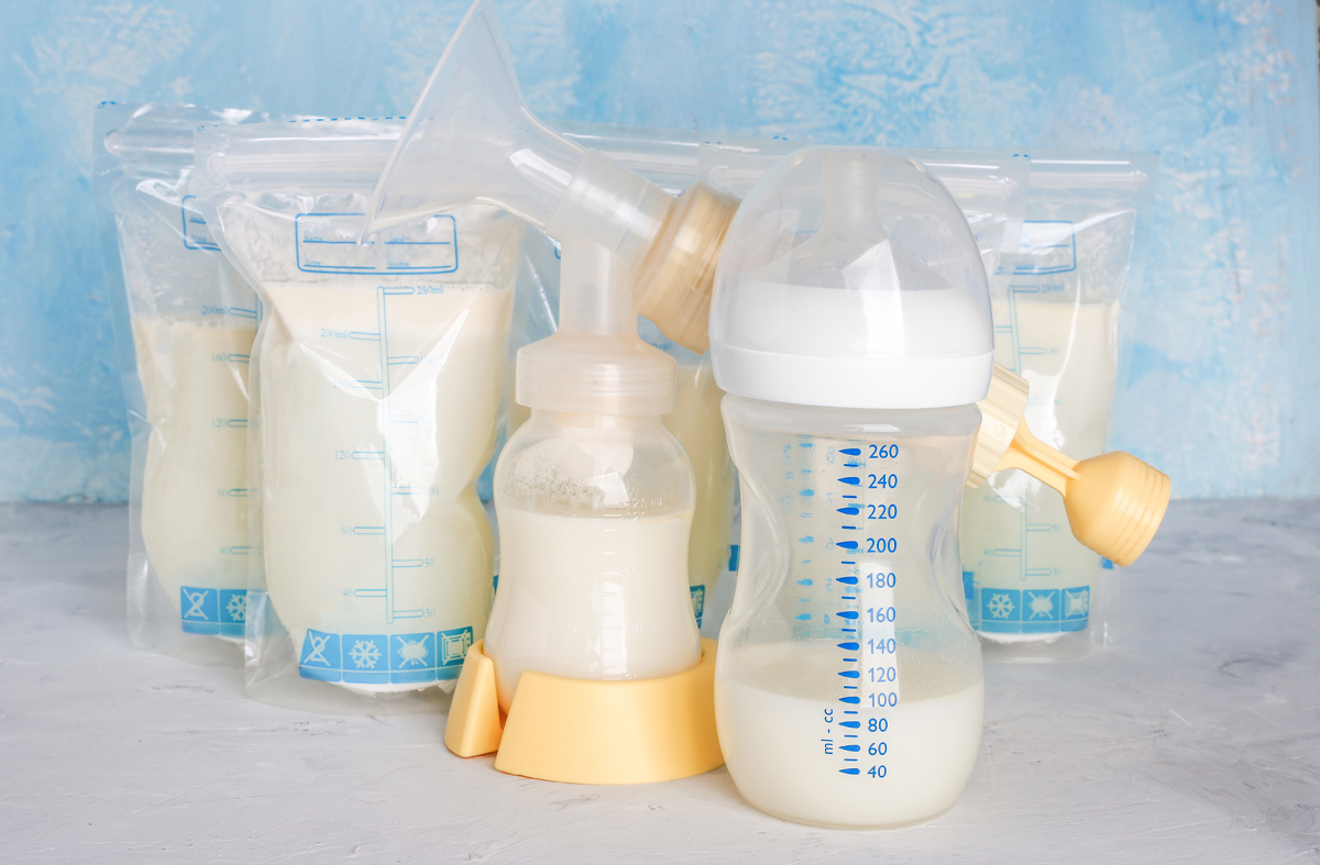 Bags with breast milk. Breast pump on yellow background. Milk bank, storing breast milk