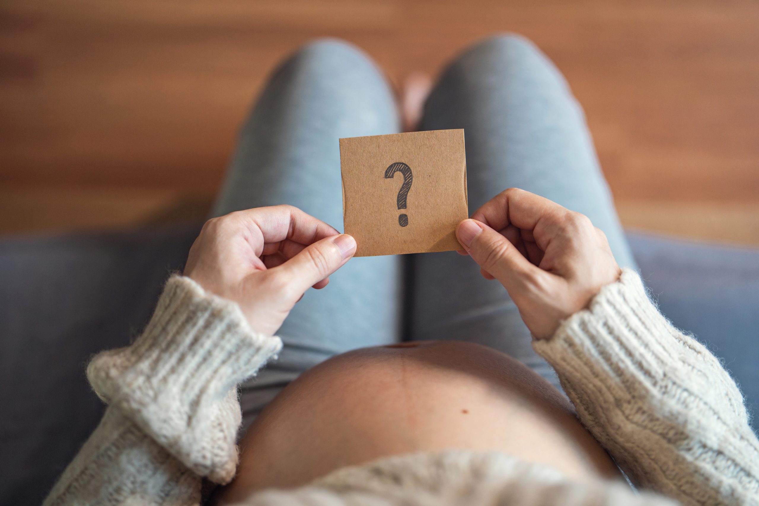 Pregnant woman looking at a question mark wondering about What is a Closed System Breast Pump?