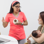 Pumps for Mom a mom holding baby at the doctors for breast feeding and pumping support - talking with a lactation consultant